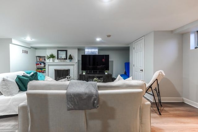 living room featuring a fireplace and light hardwood / wood-style flooring