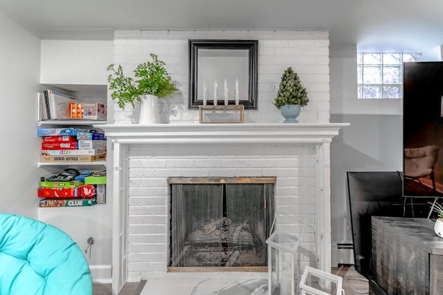 interior details with a fireplace and baseboard heating