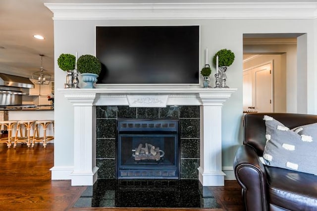 interior space featuring dark hardwood / wood-style flooring, crown molding, and a tile fireplace