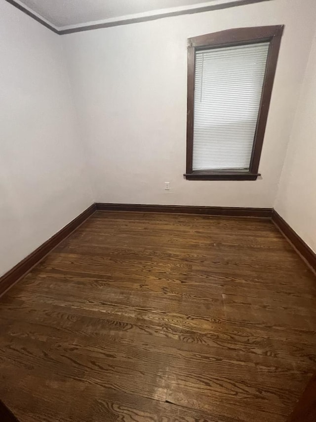 empty room with dark hardwood / wood-style floors