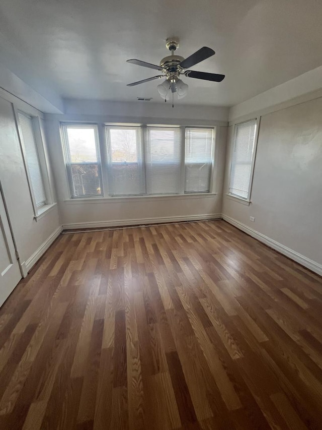 unfurnished sunroom with ceiling fan