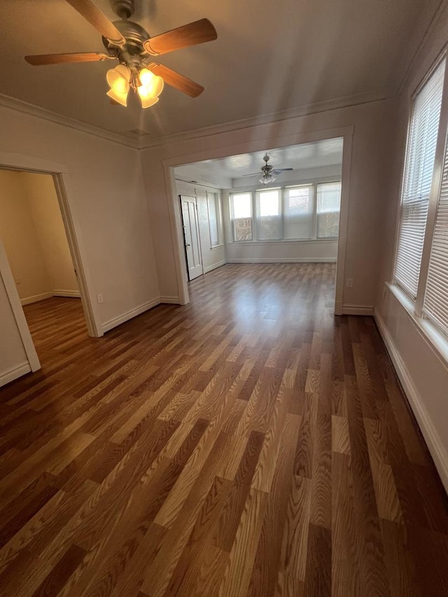 empty room with dark wood-type flooring and ornamental molding