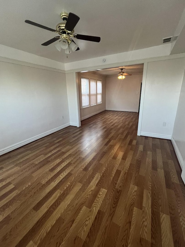 spare room with dark hardwood / wood-style floors and ceiling fan