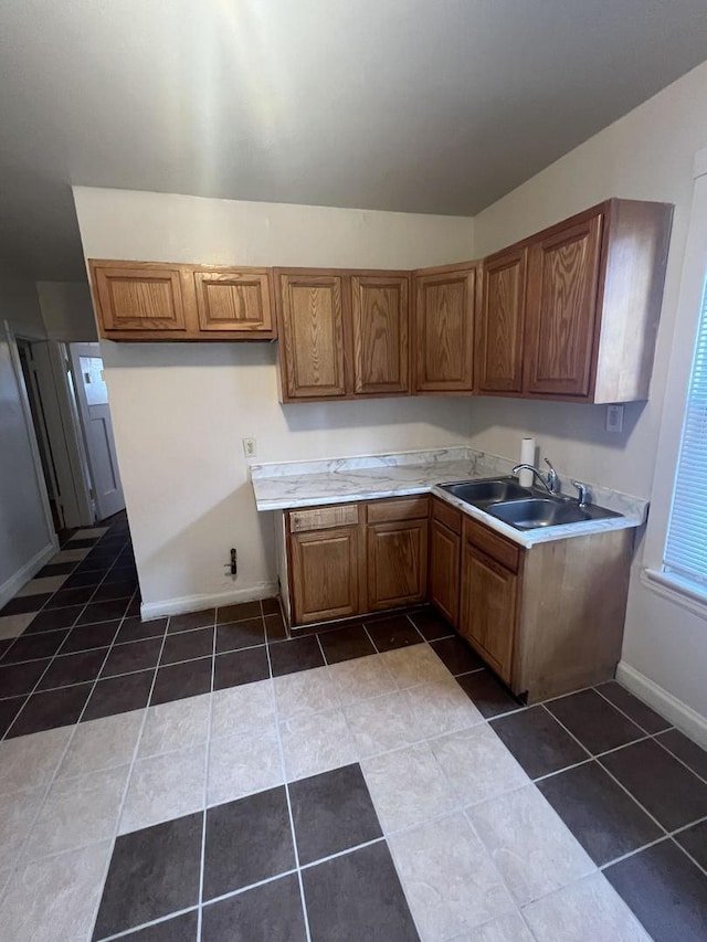 kitchen featuring sink and dark tile patterned floors