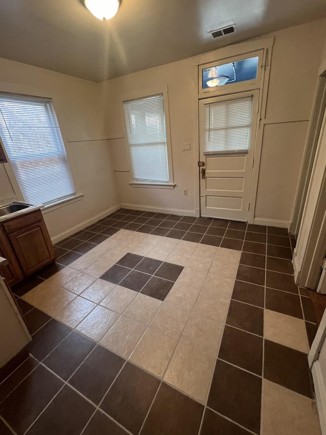 doorway featuring dark tile patterned flooring