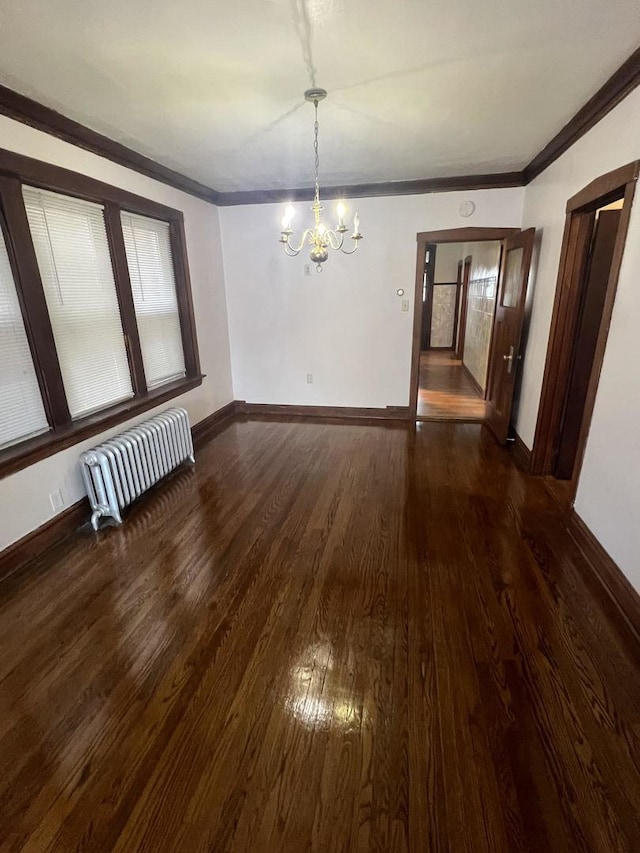 unfurnished dining area featuring dark wood-type flooring, crown molding, radiator, and a chandelier