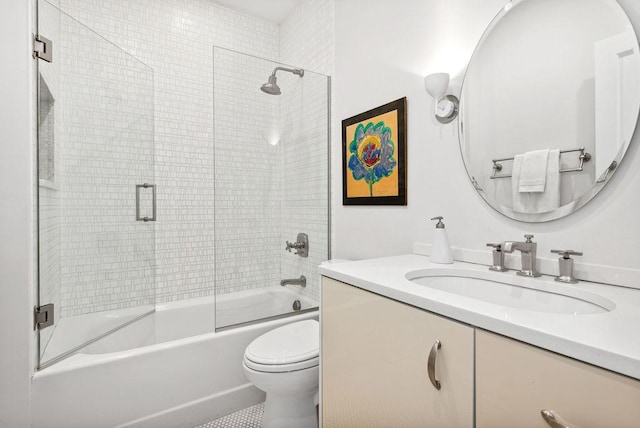 full bathroom featuring vanity, combined bath / shower with glass door, and toilet