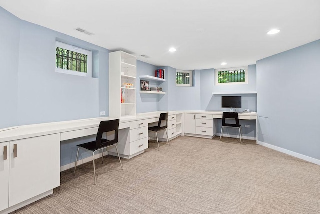 office space featuring light colored carpet and built in desk