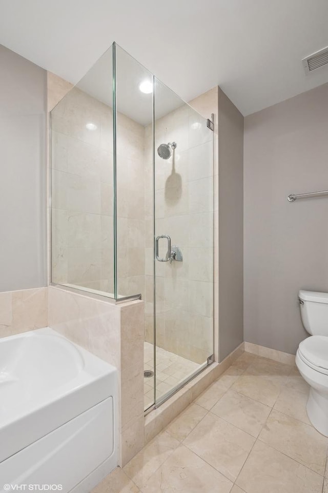 bathroom with tile patterned flooring, separate shower and tub, and toilet