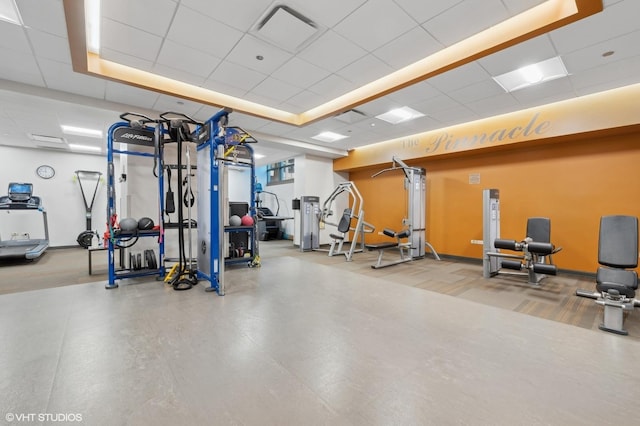 gym with a paneled ceiling