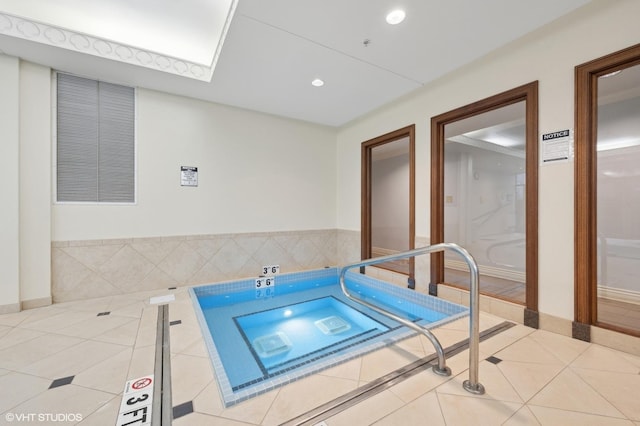 view of swimming pool with an indoor in ground hot tub