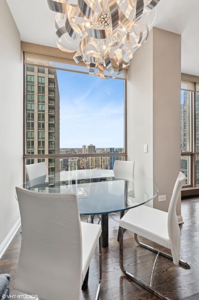 dining room featuring an inviting chandelier, floor to ceiling windows, and dark wood-type flooring