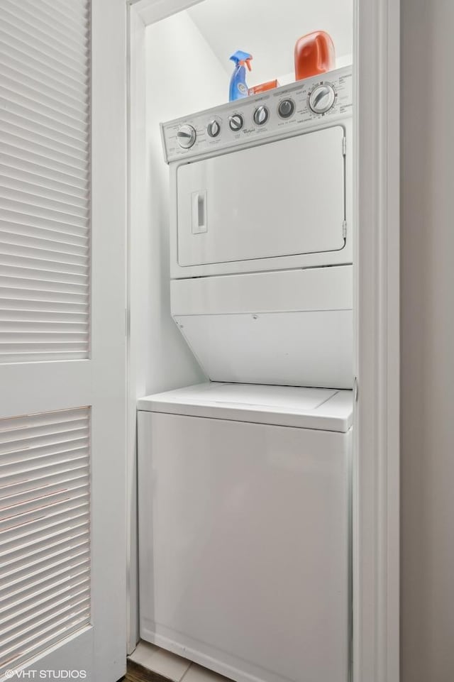 washroom featuring stacked washer and clothes dryer