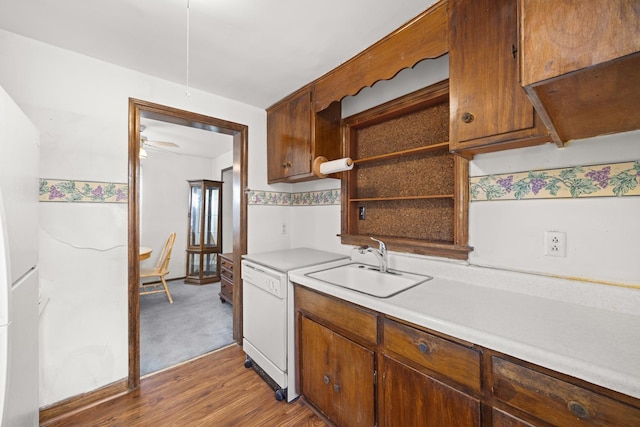 kitchen featuring ceiling fan, dishwasher, sink, and hardwood / wood-style floors