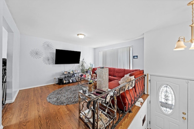 living room with an inviting chandelier and hardwood / wood-style floors