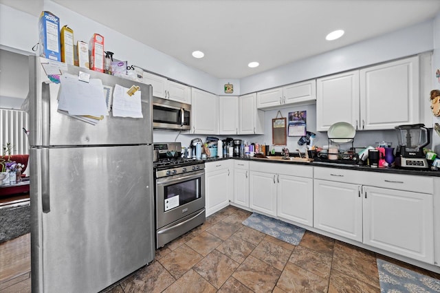 kitchen with stainless steel appliances, sink, and white cabinets