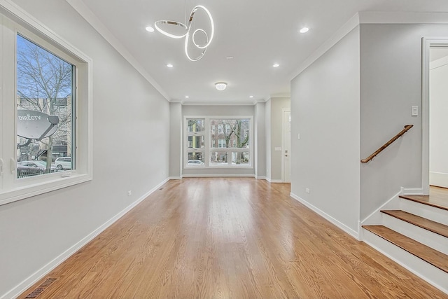 unfurnished living room featuring crown molding and light hardwood / wood-style flooring