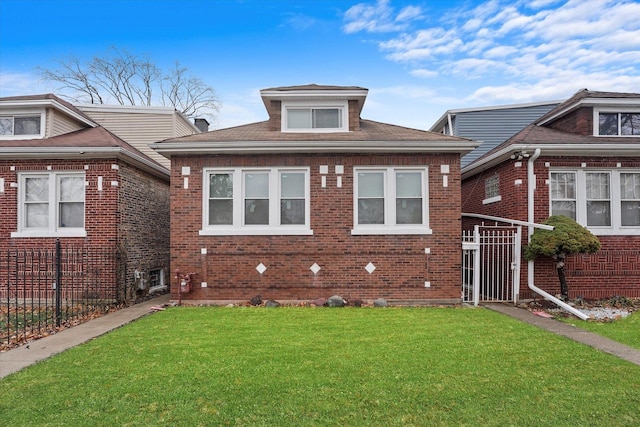 view of front of house with brick siding and a front yard