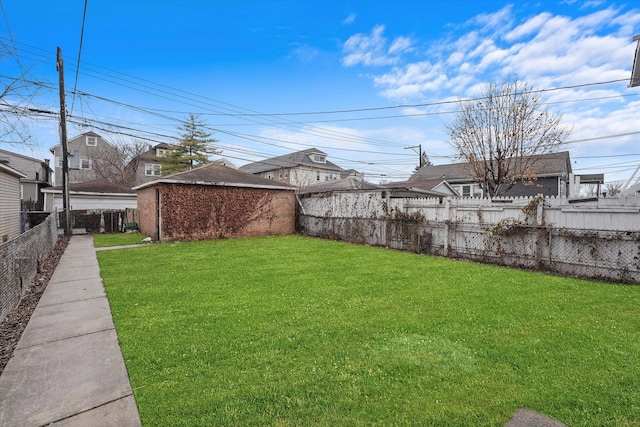 view of yard featuring a fenced backyard and an outbuilding