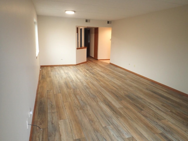 unfurnished room with light hardwood / wood-style floors