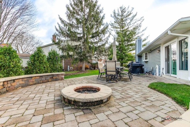 view of patio / terrace featuring a grill and a fire pit