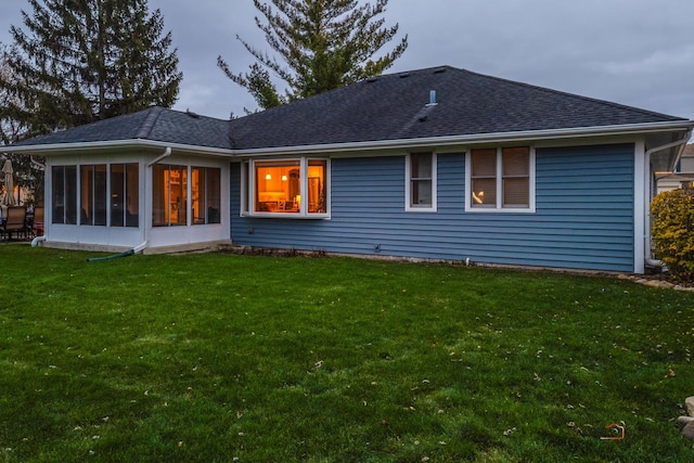 back of house featuring a sunroom and a yard