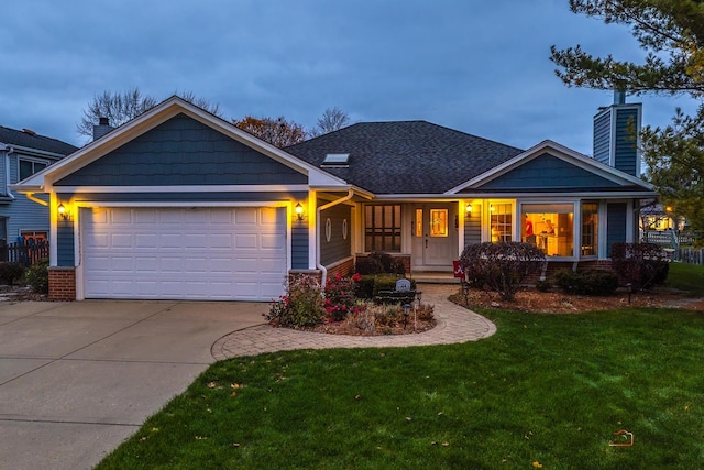 craftsman-style house with a garage and a lawn