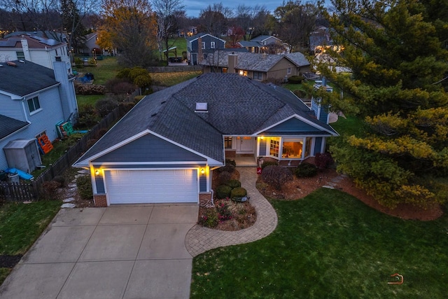 view of front of home featuring a garage and a lawn