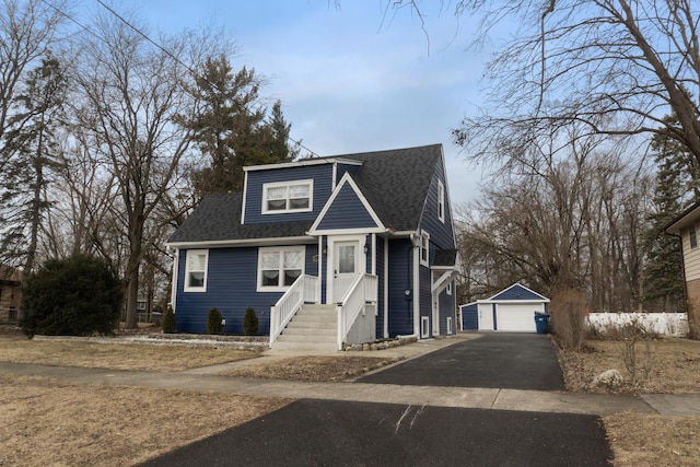 view of front of home with a garage and an outdoor structure