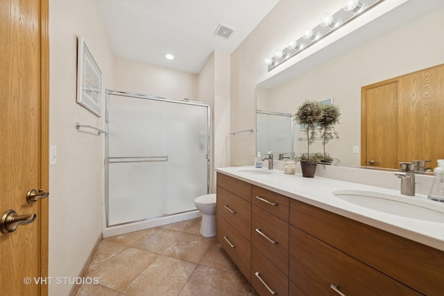 bathroom with an enclosed shower, vanity, tile patterned flooring, and toilet