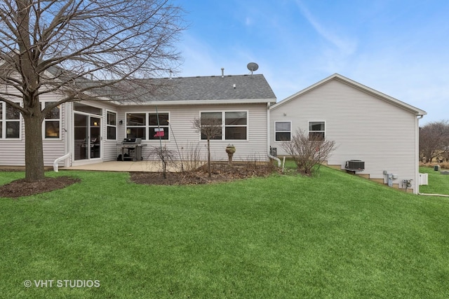 back of house featuring a lawn and a patio