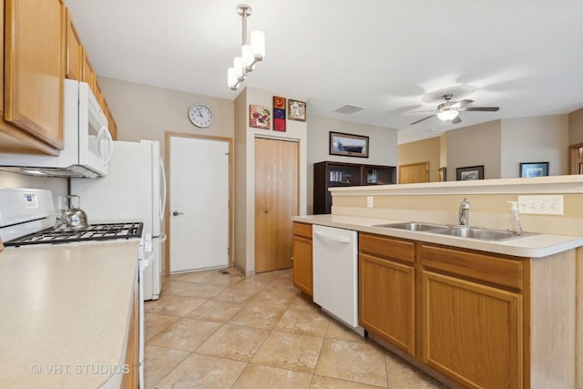 kitchen with pendant lighting, sink, light tile patterned floors, ceiling fan, and white appliances