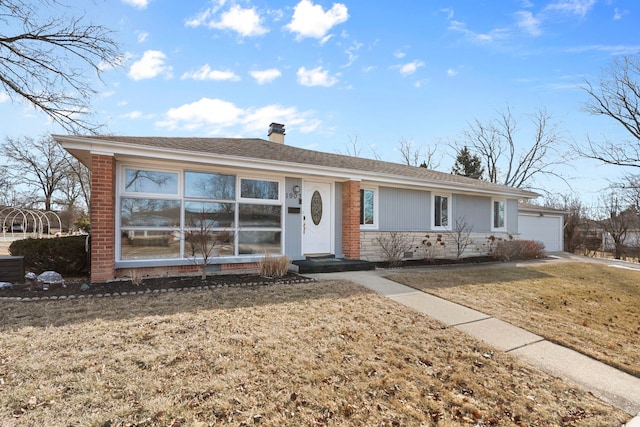 ranch-style house with a garage and a front lawn