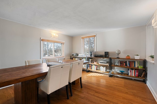 dining space with hardwood / wood-style flooring