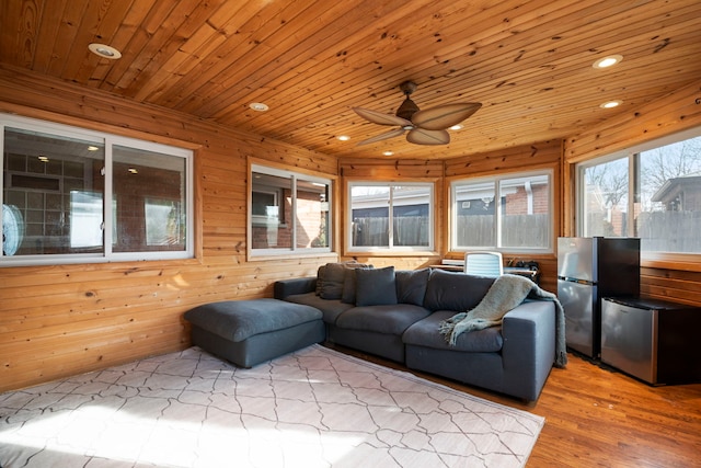 sunroom with wooden ceiling and ceiling fan