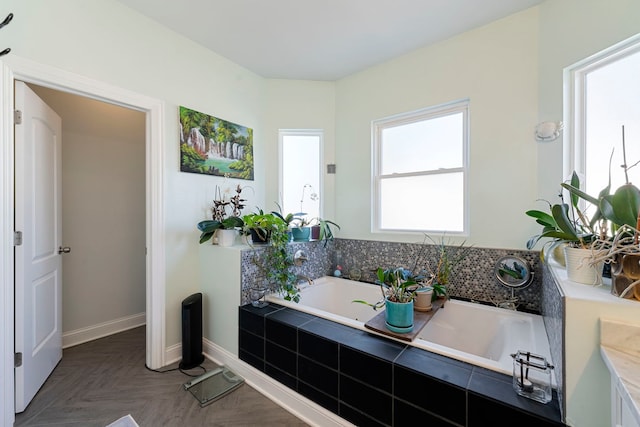 bathroom with tiled tub and parquet floors