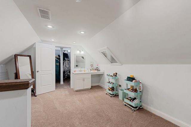 bonus room featuring vaulted ceiling and light colored carpet