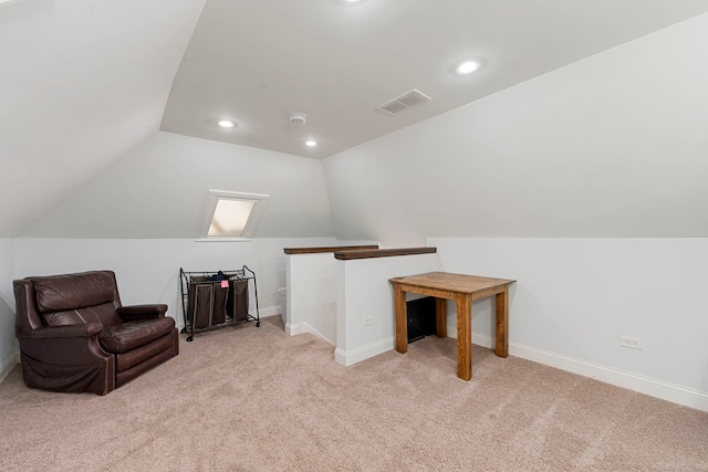 sitting room with lofted ceiling and light carpet