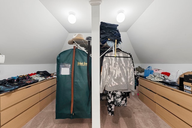 walk in closet featuring vaulted ceiling and carpet floors