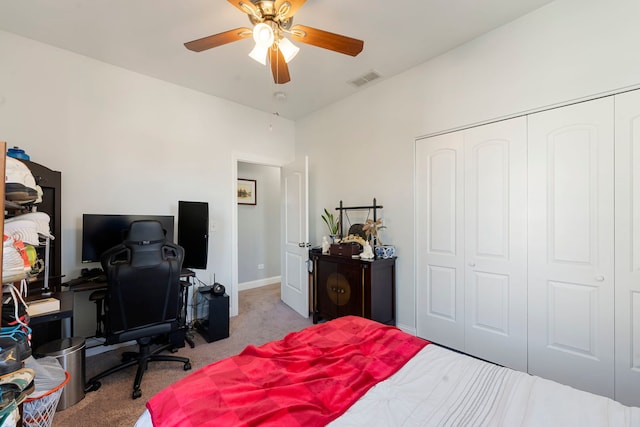 carpeted bedroom featuring ceiling fan and a closet