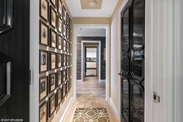 corridor featuring crown molding and light parquet floors