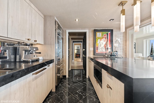 kitchen with tasteful backsplash, appliances with stainless steel finishes, pendant lighting, and light brown cabinetry