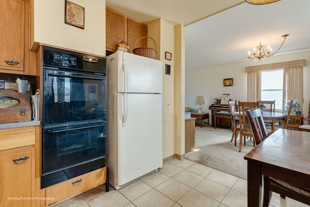 kitchen with double oven, white fridge, a notable chandelier, pendant lighting, and light colored carpet