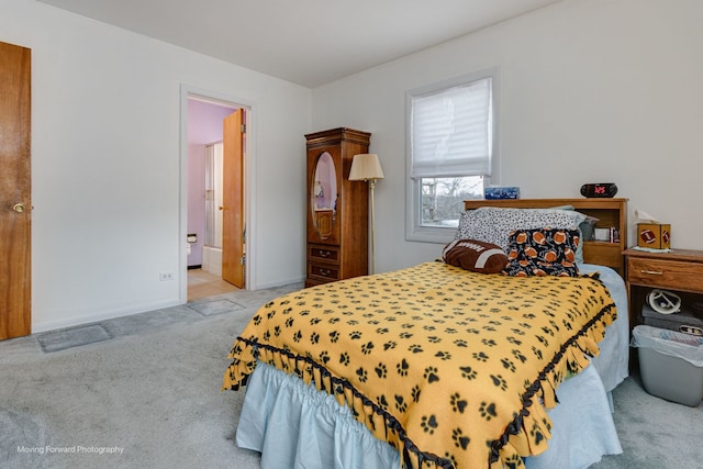 carpeted bedroom featuring ensuite bath