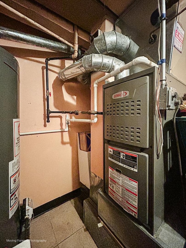 utility room featuring water heater