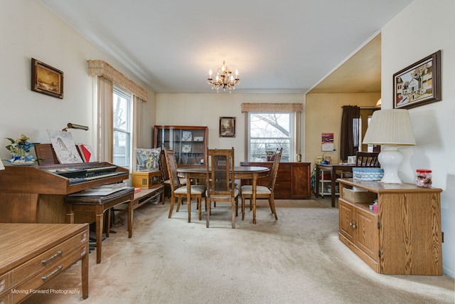 carpeted dining room with a wealth of natural light and a chandelier