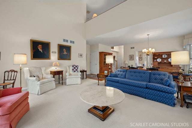 carpeted living room with a high ceiling and a notable chandelier