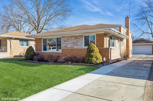 view of front of property with an outbuilding, a garage, and a front yard