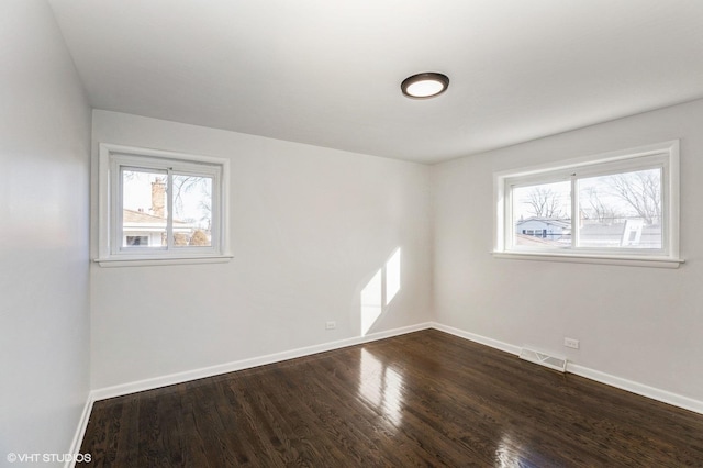 unfurnished room with wood-type flooring