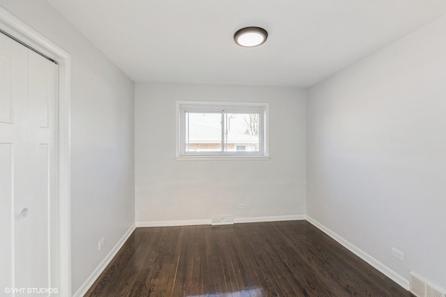 unfurnished room featuring dark hardwood / wood-style flooring